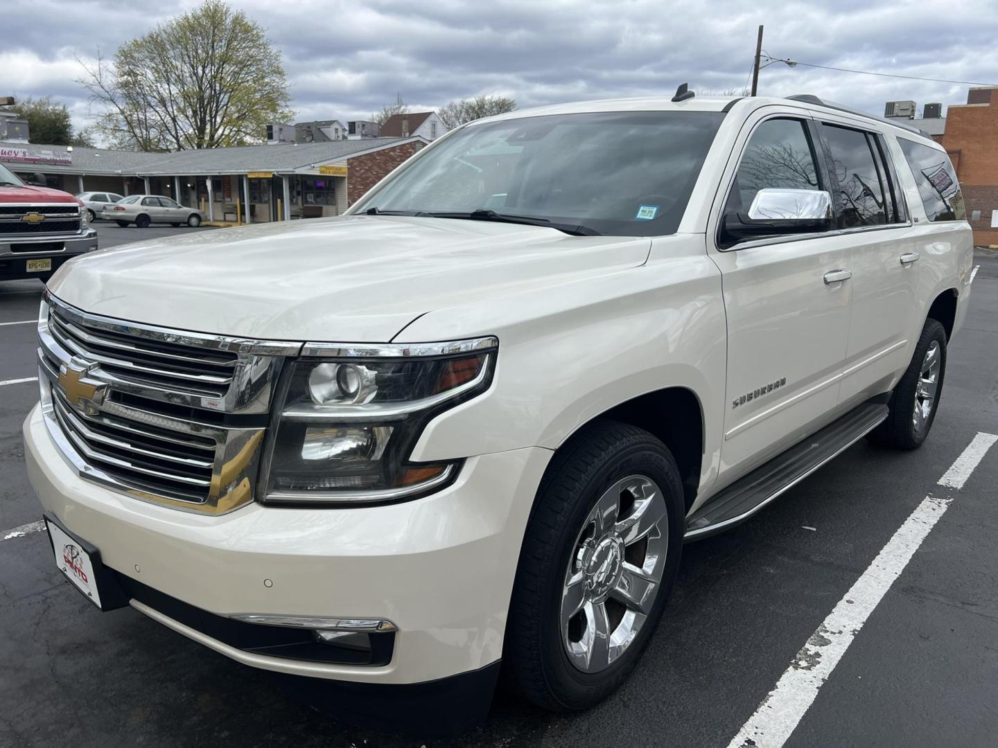 2015 White /Burgundy Chevrolet Suburban LTZ 1500 4WD (1GNSKKKCXFR) with an 5.3L V8 OHV 16V engine, 6-Speed Automatic transmission, located at 1018 Brunswick Ave, Trenton, NJ, 08638, (609) 989-0900, 40.240086, -74.748085 - Photo#0